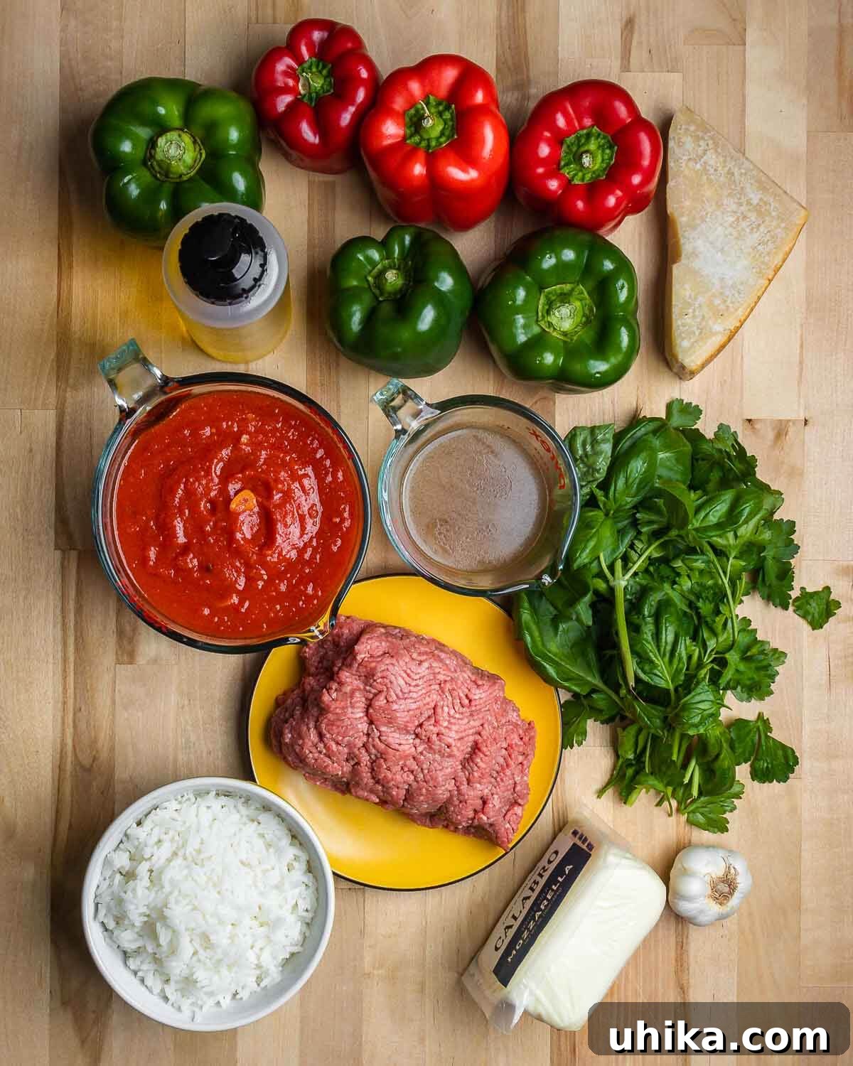 Tuscan Harvest Bells 3 A vibrant array of fresh ingredients for Italian stuffed peppers: bell peppers, Pecorino, olive oil, marinara sauce, beef stock, parsley, basil, ground chuck, rice, mozzarella, and garlic.