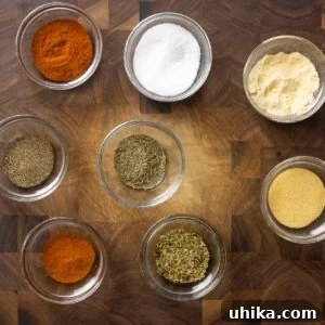 Cajun seasoning featured image with bowls of spices on cutting board.