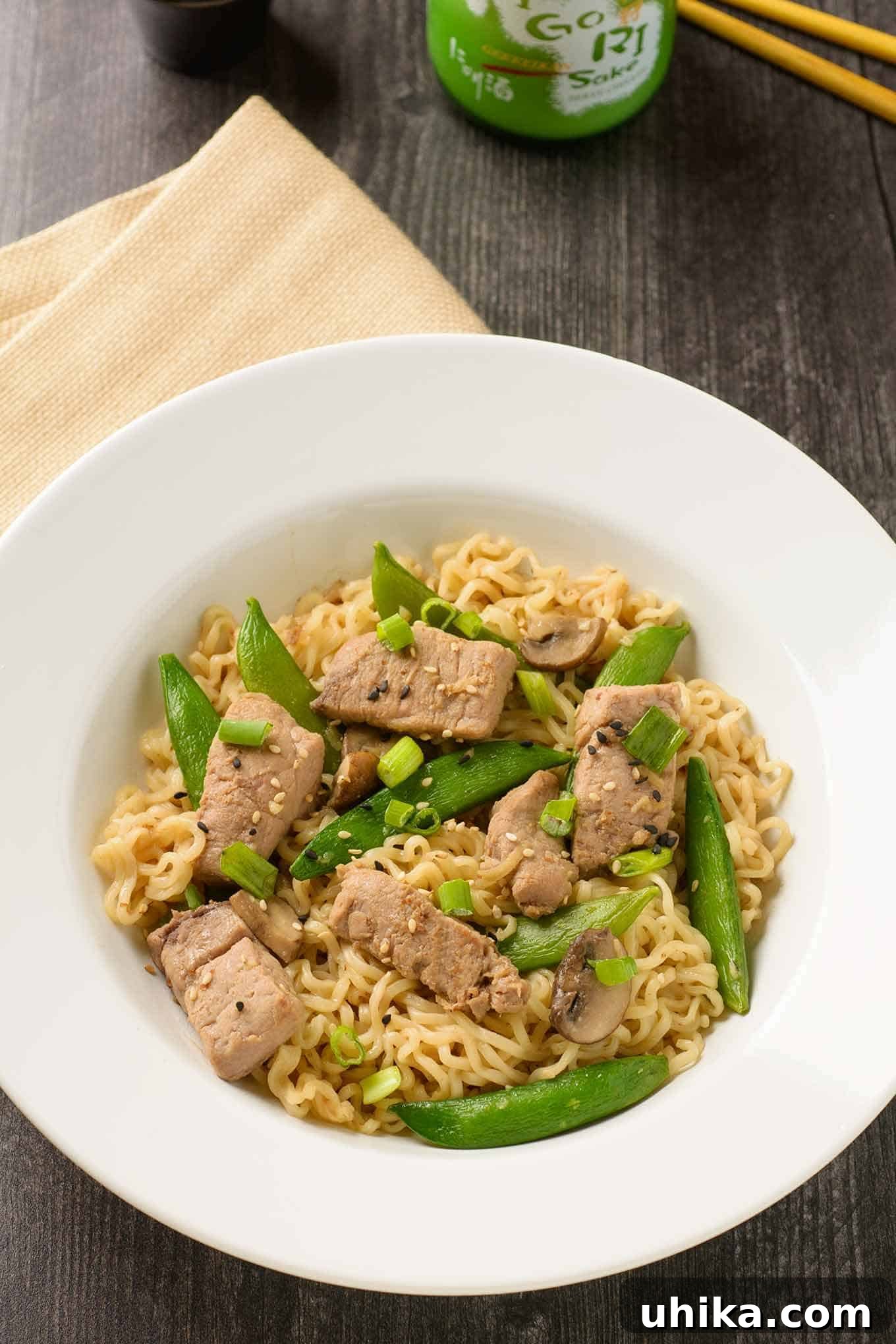 Skillet Pork Ramen 2 A shallow bowl of ramen noodles tossed with stir-fried pork, sugar snap peas, and scallions in soy-ginger sauce.