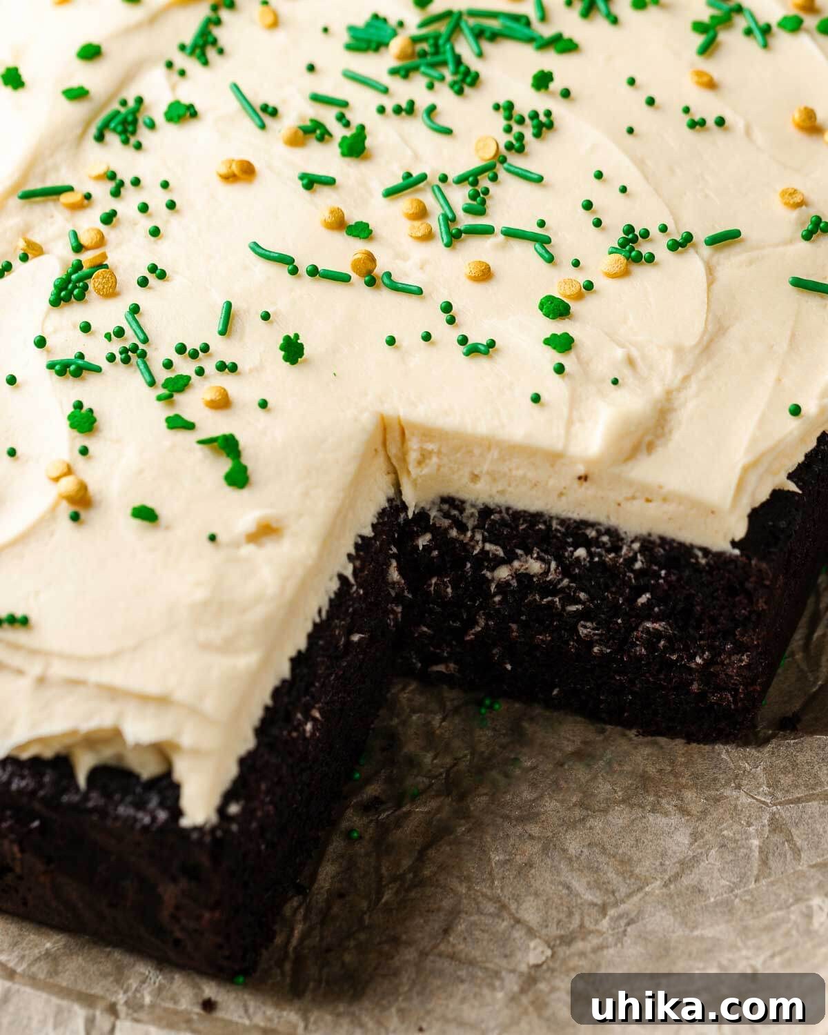 Velvet Guinness Chocolate Cake with Baileys Irish Cream Frosting 10 A beautifully frosted Chocolate Guinness Cake adorned with festive green and white Irish sprinkles, ready to be sliced.