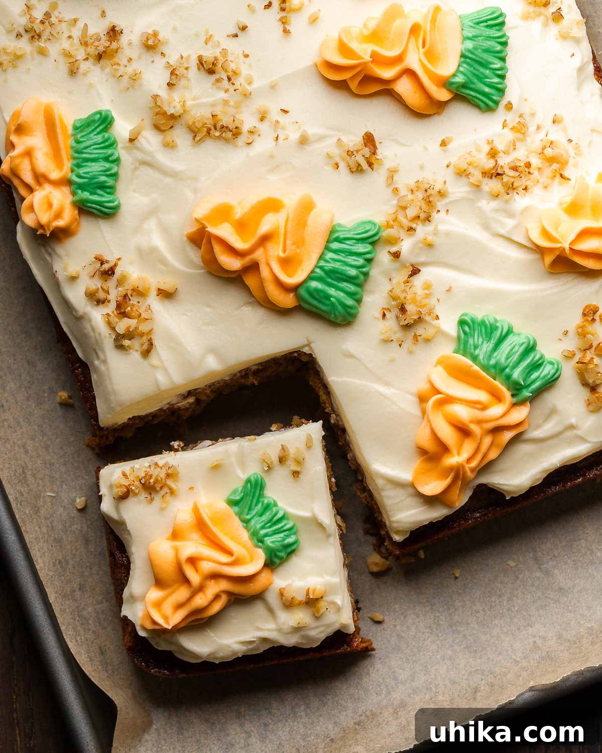 Carrot Cake Bliss 9 A large, beautifully frosted carrot cake rests on a parchment-lined baking sheet, with a single slice perfectly cut and placed slightly to the side, revealing its moist, spiced interior.