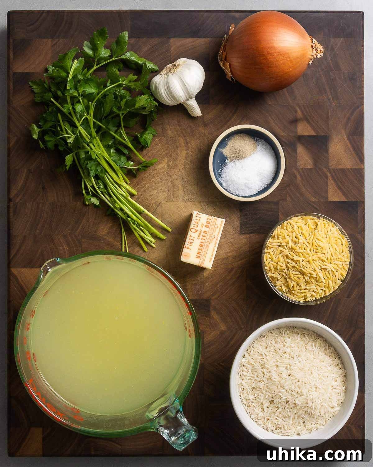 Aromatic Buttered Rice 3 Pirinç pilavı tarifi için gerekli tüm malzemeler: taze maydanoz, sarımsak, soğan, tuz, beyaz biber, tereyağı, arpa şehriye, tavuk suyu ve pirinç.