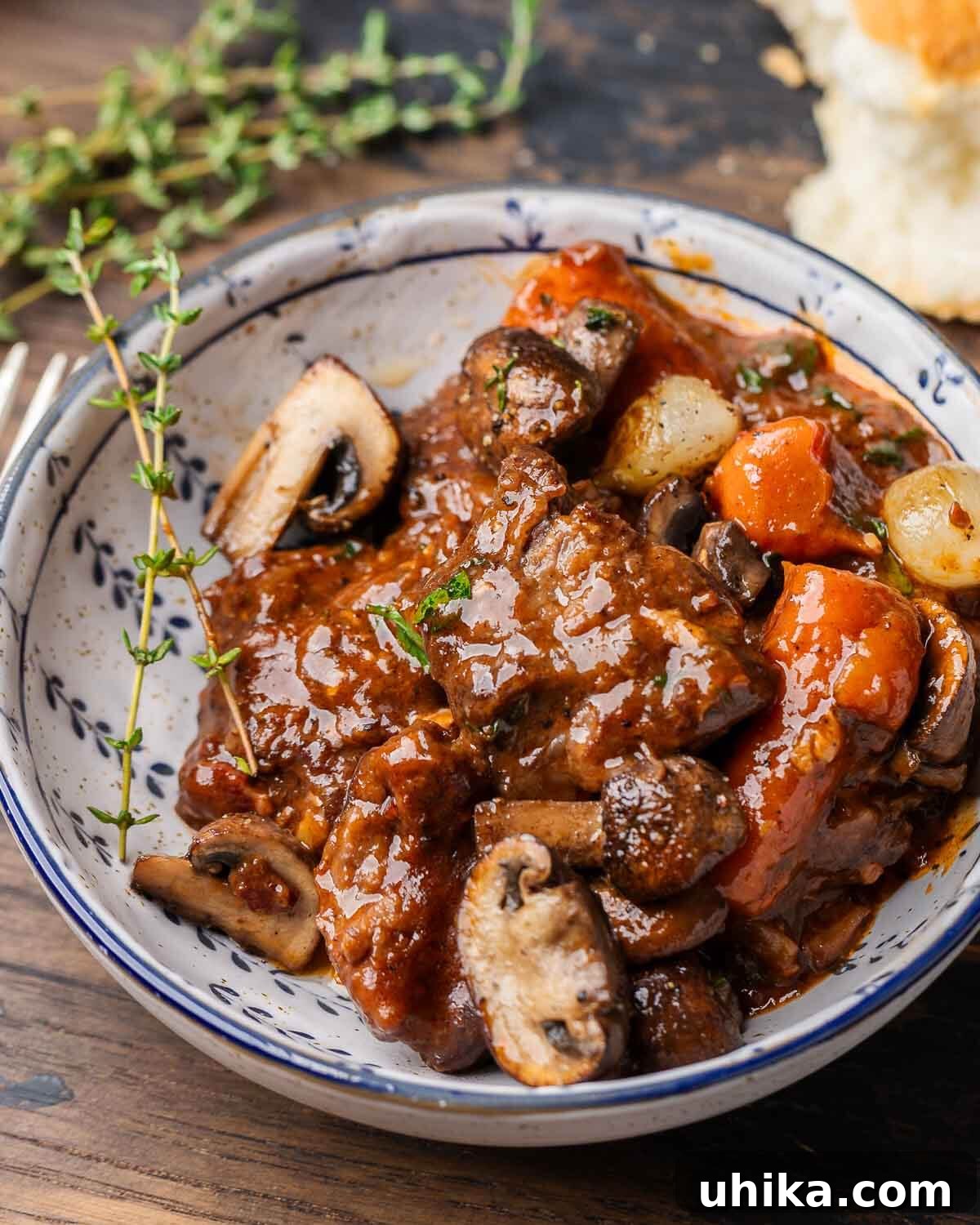 The Magic of Shared Meals Unboxing Two Costco Desserts with Family 2 A hearty Beef Bourguignon, garnished with fresh thyme, served in a pristine white bowl, inviting a comforting and gourmet dining experience.