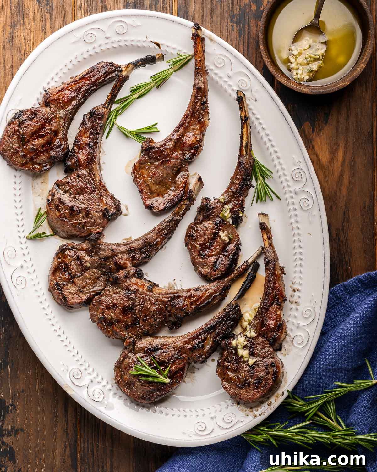 Chargrilled Lamb Rib Chops with Zesty Lemon Garlic 2 Platter of grilled lamb rib chops with bowl of lemon garlic sauce on the side.