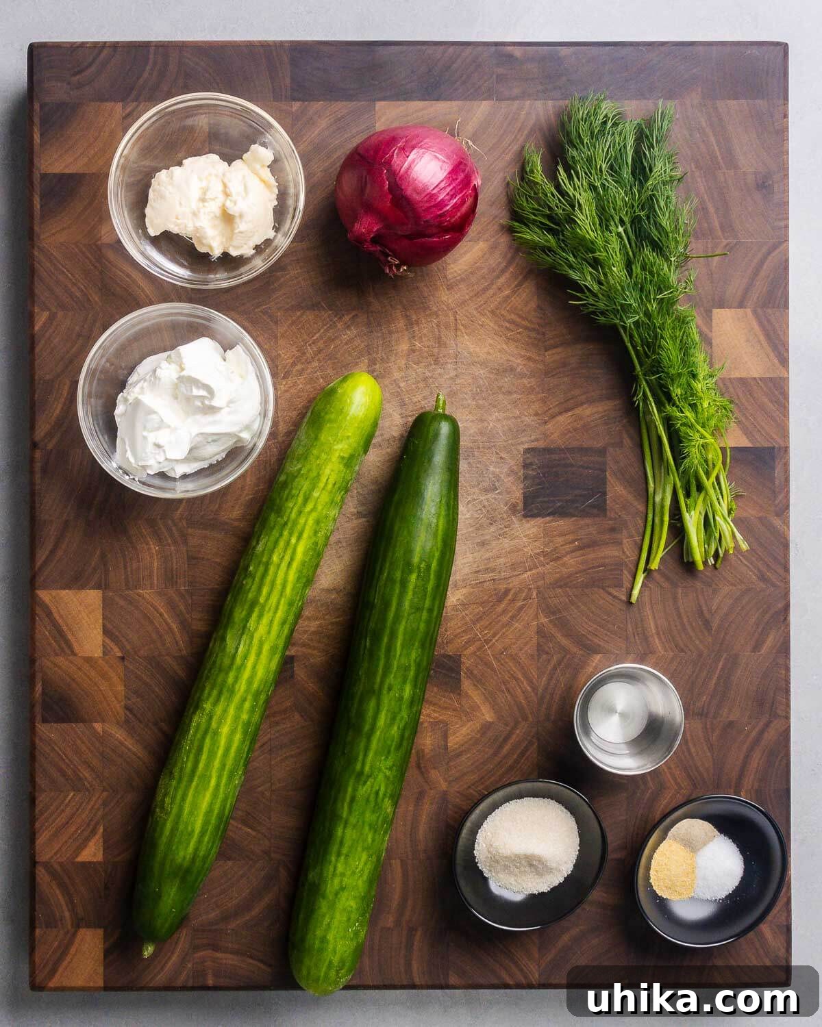 Cool Cucumber Delight 4 Ingredients shown: mayonnaise, sour cream, red onion, dill, English cucumbers, white vinegar, sugar, salt, pepper, and granulated garlic.
