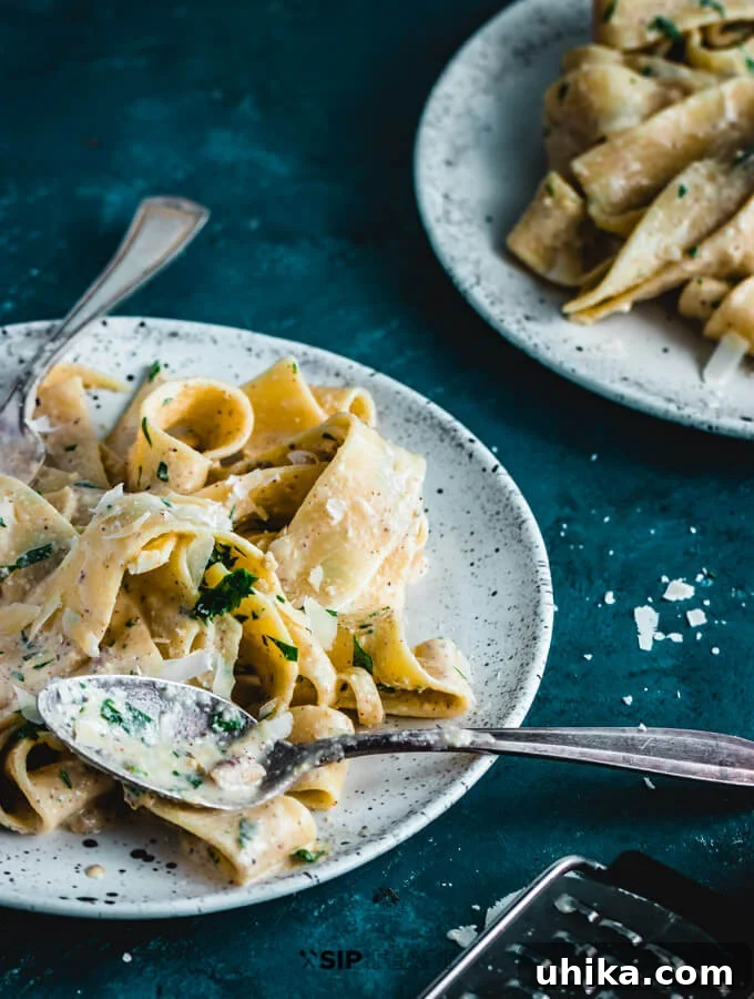 Plated Walnut Sauce Pasta - a close-up shot of a serving of pasta coated in creamy walnut sauce, garnished with fresh parsley.