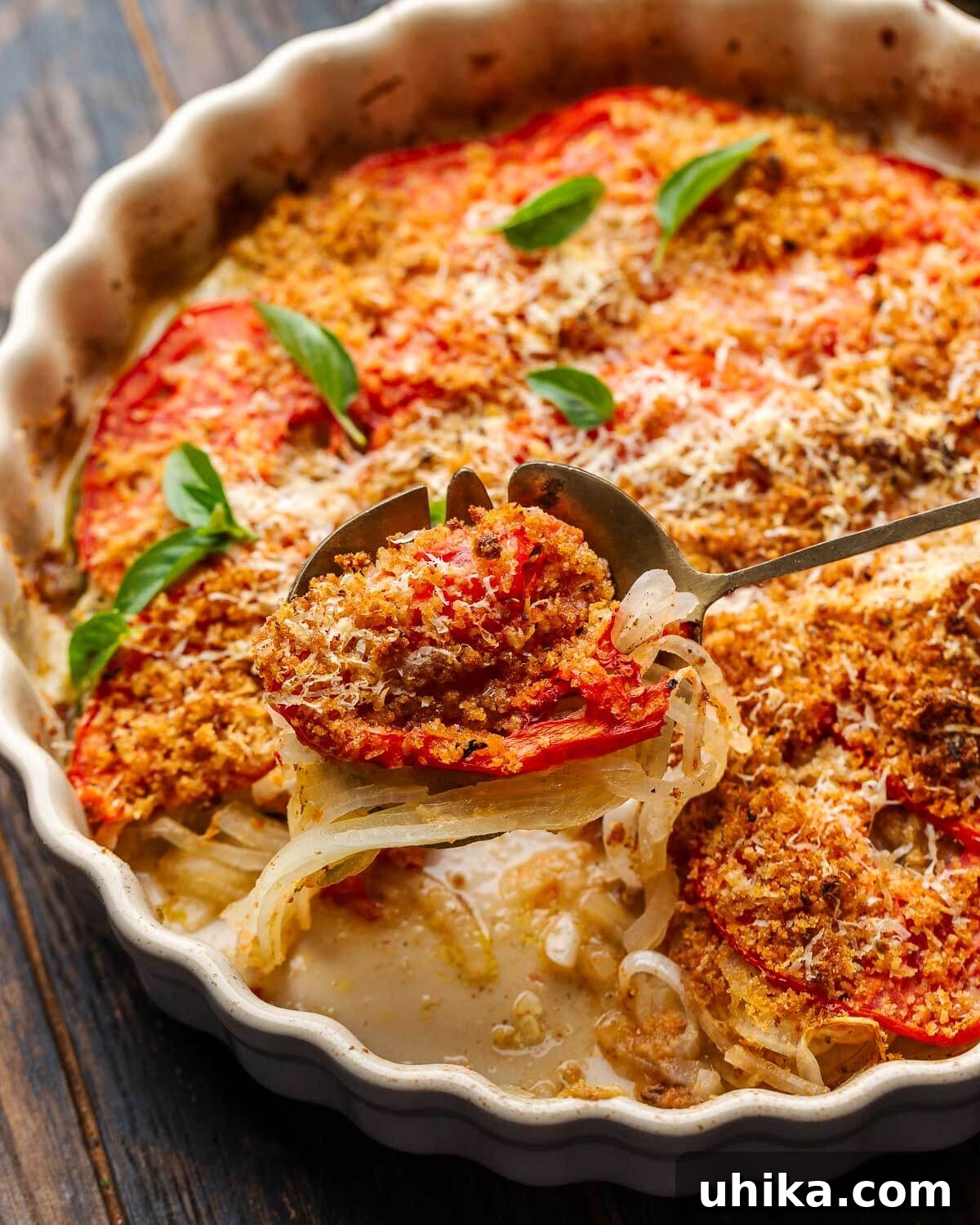 Zucchini Parmesan Bake 7 Spoon holding a scoop of Italian zucchini casserole over a baking dish, garnished with fresh basil.