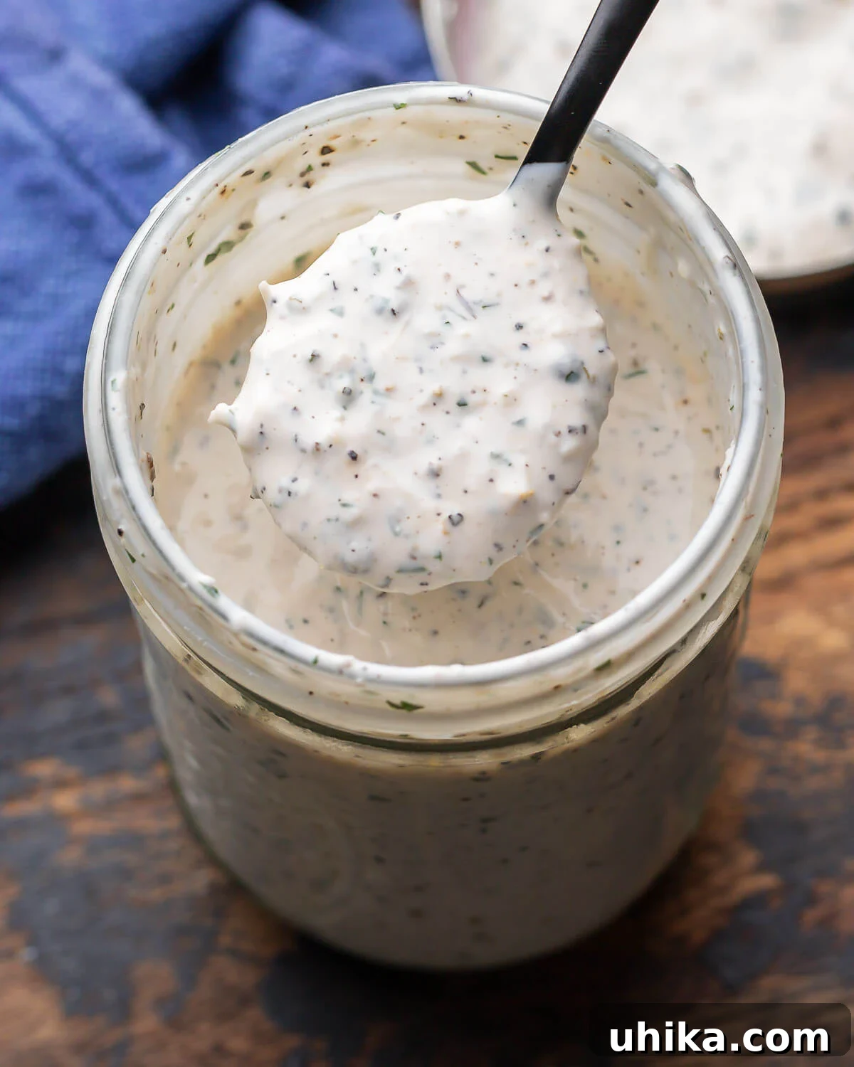 Velvety Parmesan Peppercorn Dressing 2 Creamy parmesan peppercorn dressing in mason jar.