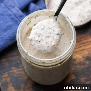 Velvety Parmesan Peppercorn Dressing 5 Creamy parmesan peppercorn dressing in mason jar.