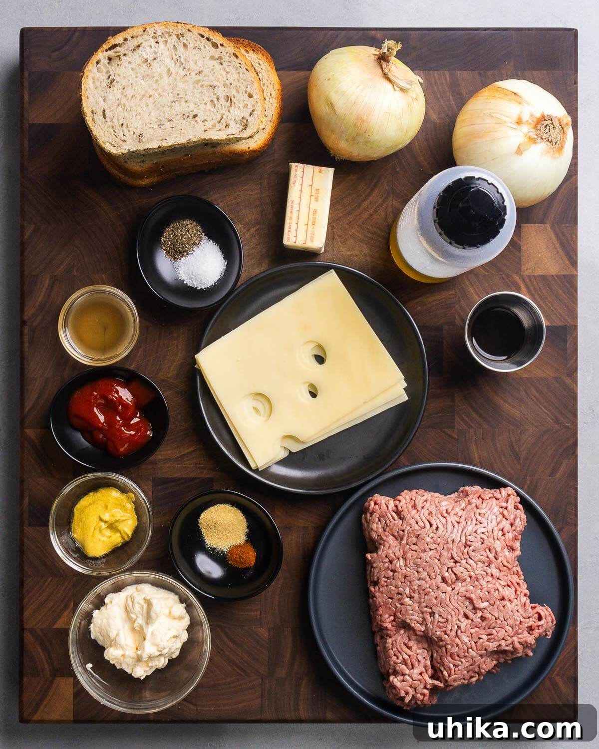 Diner's Delight The Timeless Patty Melt 2 Ingredients shown: rye bread, onions, butter, olive oil, worcestershire sauce, salt, pepper, cider vinegar, swiss cheese, ketchup, Dijon mustard, mayonnaise, spices, and ground beef.