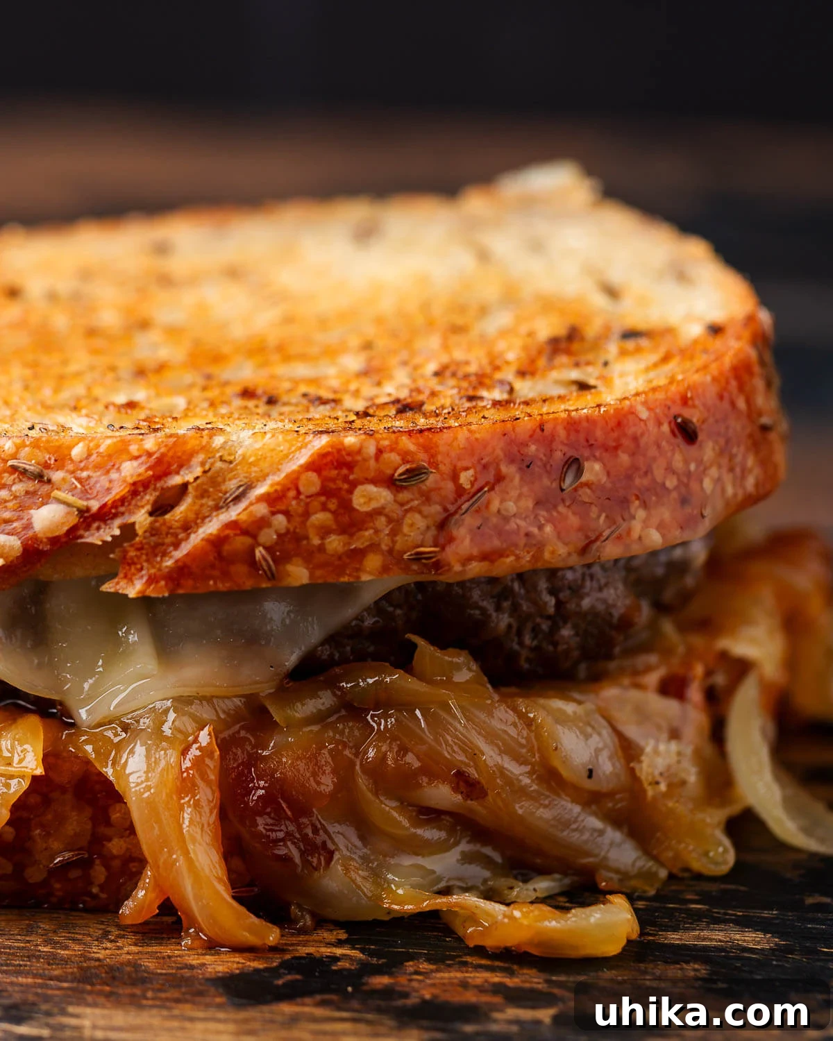 Diner's Delight The Timeless Patty Melt 5 Patty melt on wooden board.