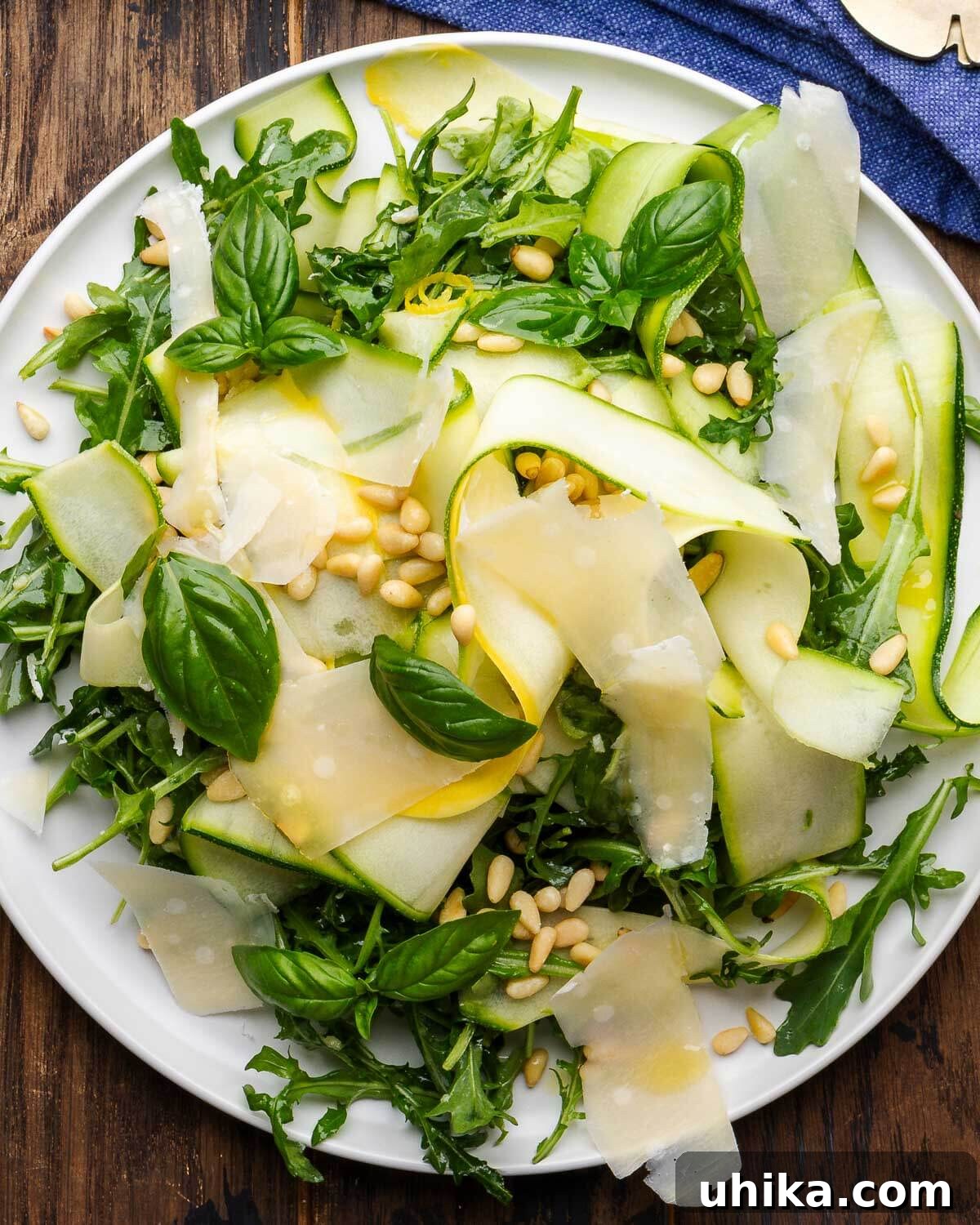 Refreshing Zucchini Ribbons Salad 6 Shaved zucchini salad on white plate with blue napkin in the background.