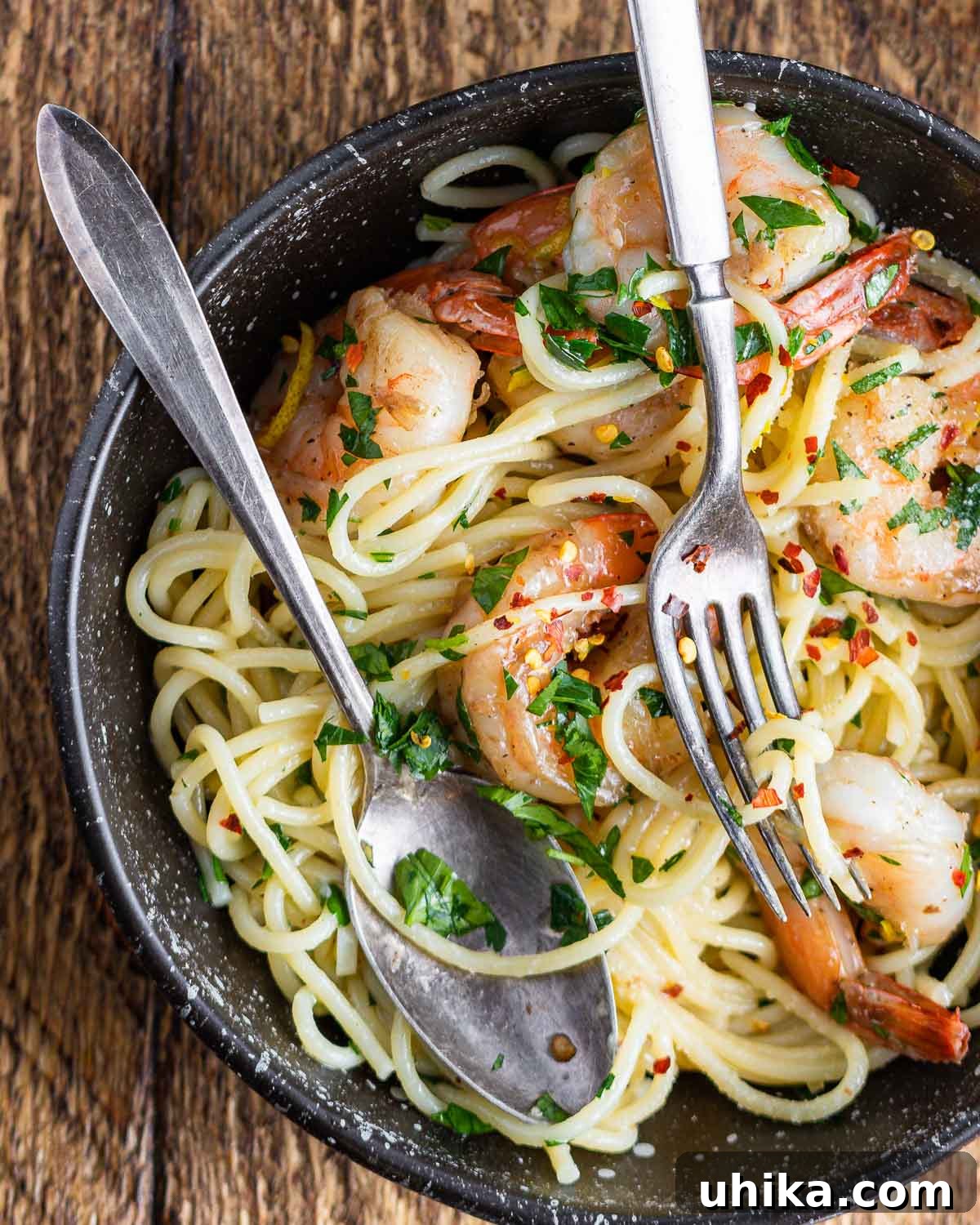 Vibrant Lemon Garlic Shrimp Pasta 7 Lemon garlic shrimp pasta in black plate on table.