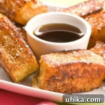 Single serving of Hawaiian French toast sticks with maple syrup.
