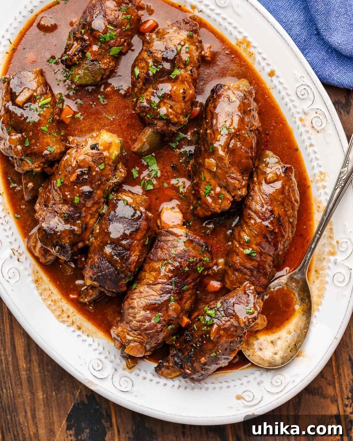 Hearty German Beef Rouladen 7 White platter with beef rouladen.
