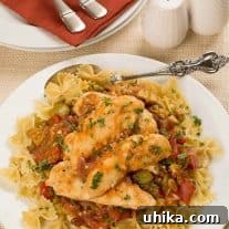 A close-up of Mediterranean Sweet and Sour Chicken served over farfalle pasta.