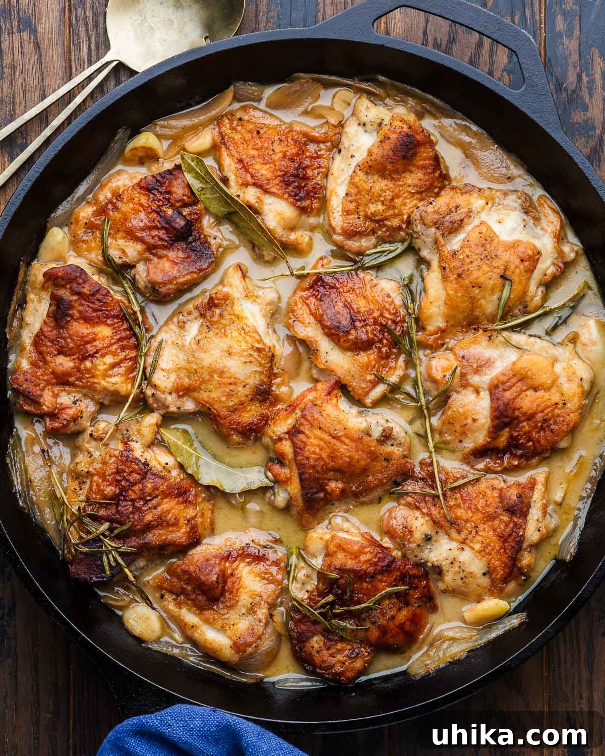 Zesty Italian Vinegar Chicken 2 Large cast iron pan with golden-brown braised Italian vinegar chicken, garnished with fresh herbs.