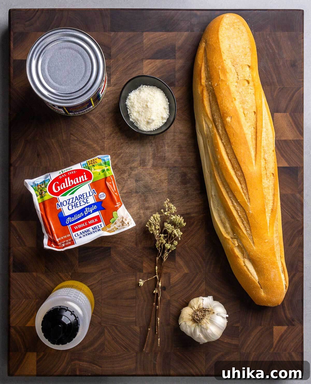Ingredients shown: canned tomatoes, Pecorino Romano, French bread, mozzarella, olive oil, Sicilian oregano, and garlic.
