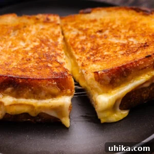 Perfectly Golden Grilled Cheese Indulgence 7 Closeup shot of sliced sourdough grilled cheese.