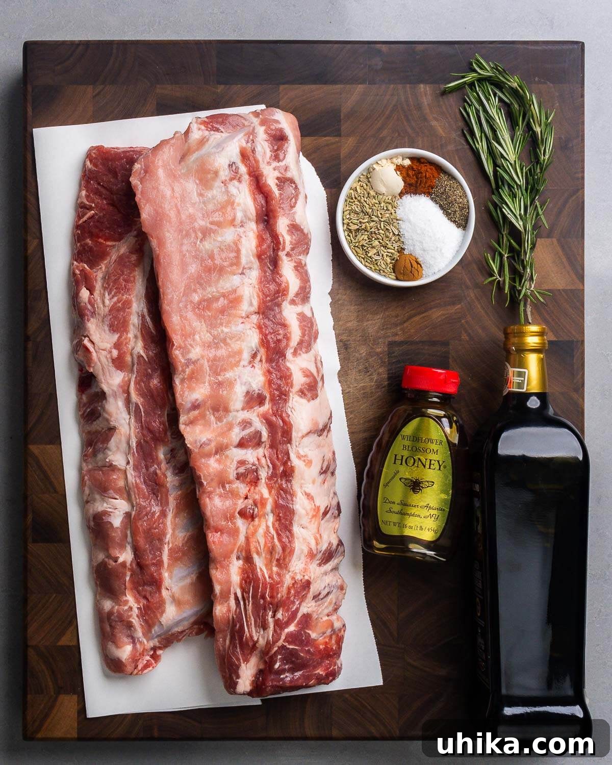 Rustic Tuscan Balsamic Glazed Ribs 3 Ingredients shown: baby back ribs, fennel seed, onion powder, salt, smoked paprika, pepper, cinnamon, kosher salt, Rosemary sprigs, honey, and balsamic vinegar.
