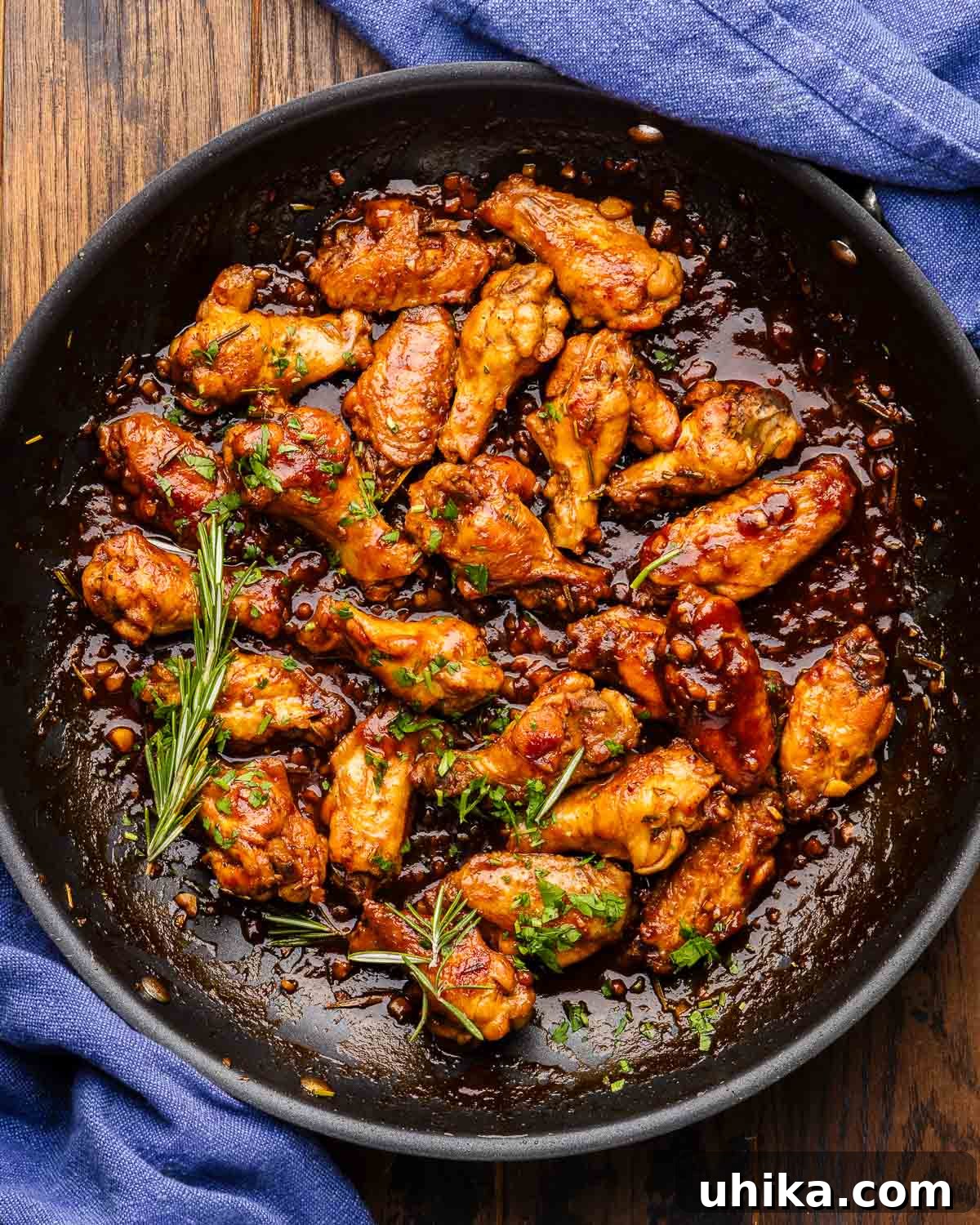 Luscious Balsamic Braised Wings 5 Overhead shot of large pan with braised balsamic wings, garnished beautifully.