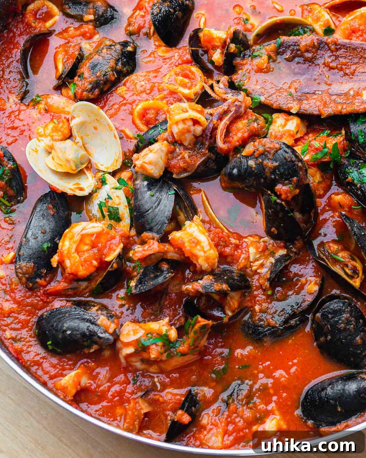 Seafood Spectacle: Recipes for Your Seven Fish Feast 2 Large pan of cooked zuppa di pesce, a rich Italian seafood stew for the Feast of the Seven Fishes.
