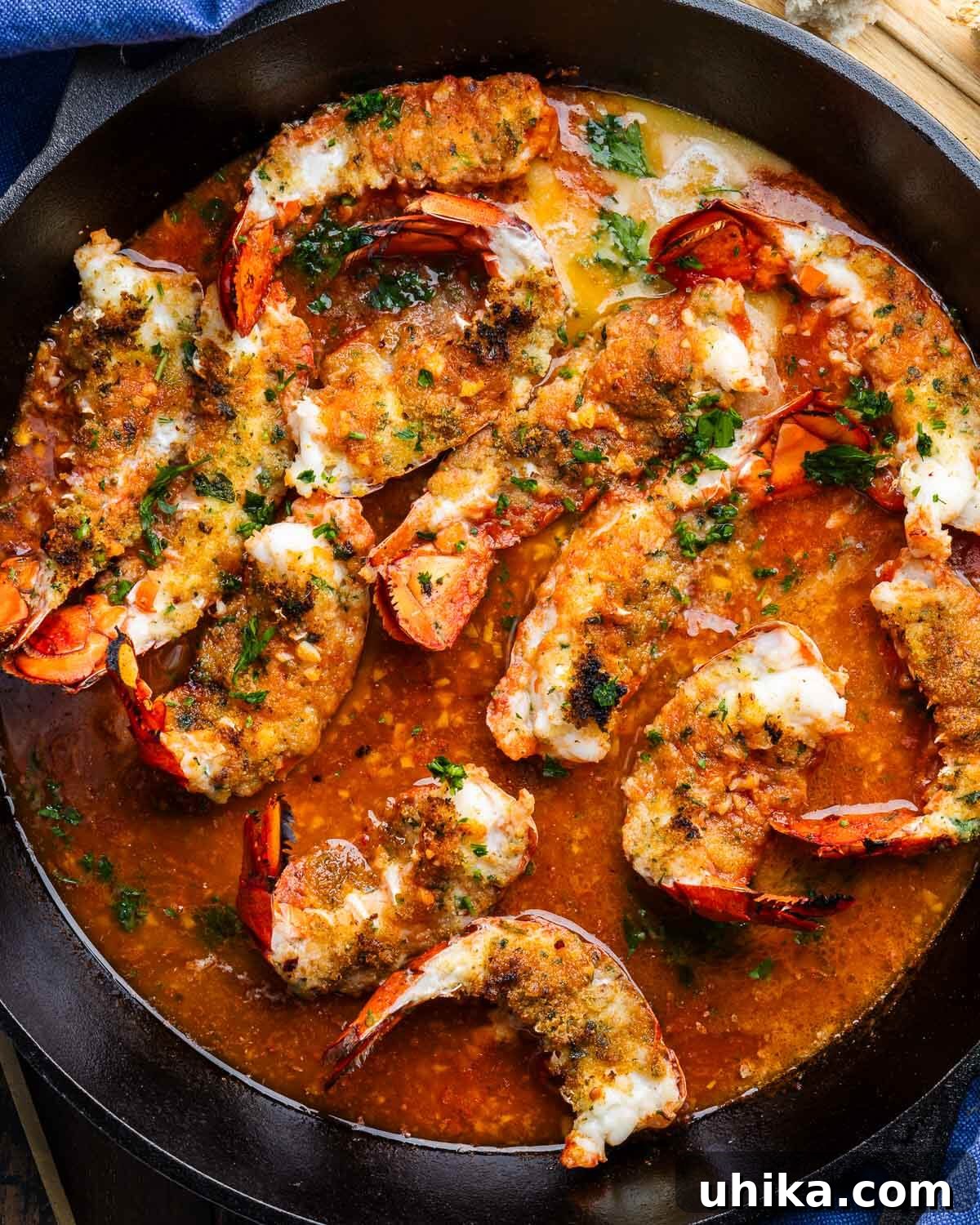 Seafood Spectacle: Recipes for Your Seven Fish Feast 8 Large pan filled with beautifully broiled Lobster Oreganata tails, golden and ready to be served.