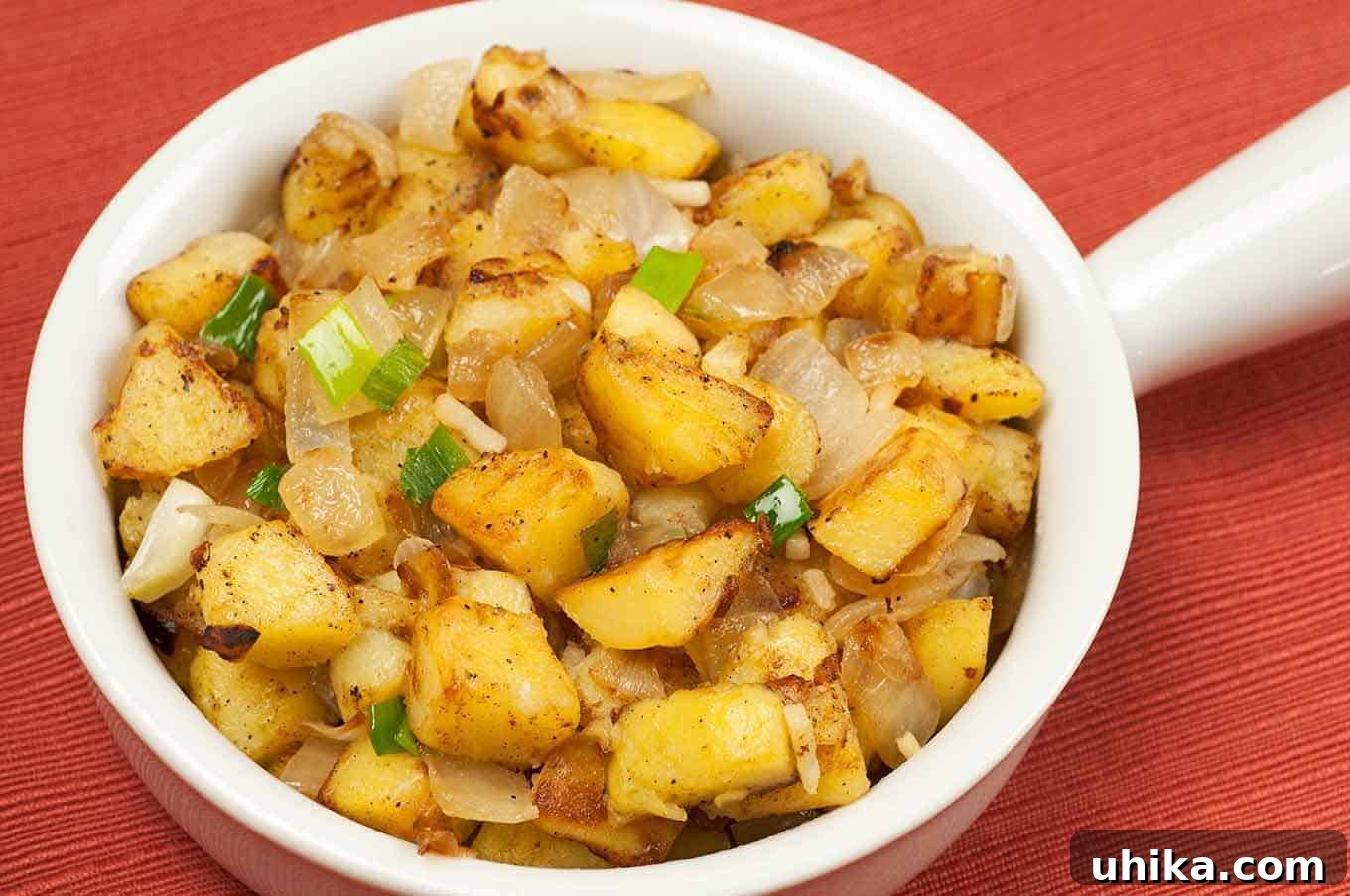 Golden Skillet Potatoes with Caramelized Onions 2 Small serving bowl with handle filled with skillet browned potatoes