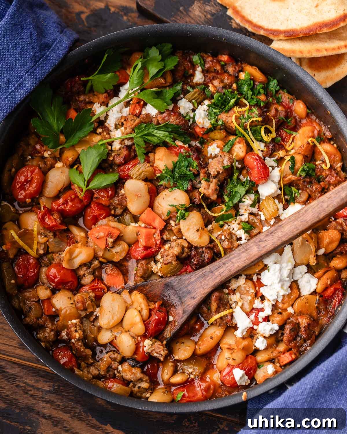 Hearty Greek Sausage and Bean Stew 2 Large pan with Greek beans and sausage, ready to be served.