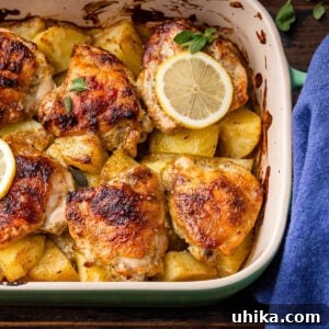 Greek lemon chicken and potatoes in baking dish, ready to serve.