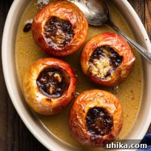 Four baked apples in a baking dish, a perfect and easy dessert.