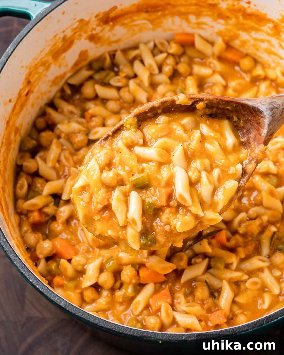 Hearty Pasta and Chickpeas 7 Wooden ladle holding pasta e ceci over Dutch oven.