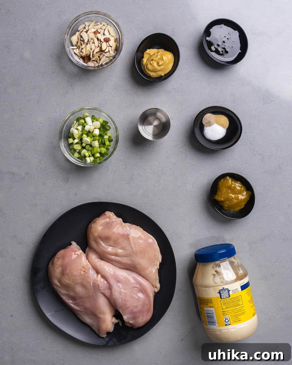 Zesty Honey Mustard Chicken Salad 4 Ingredients for honey mustard chicken salad, including chicken, honey, mustard, almonds, and green onions.