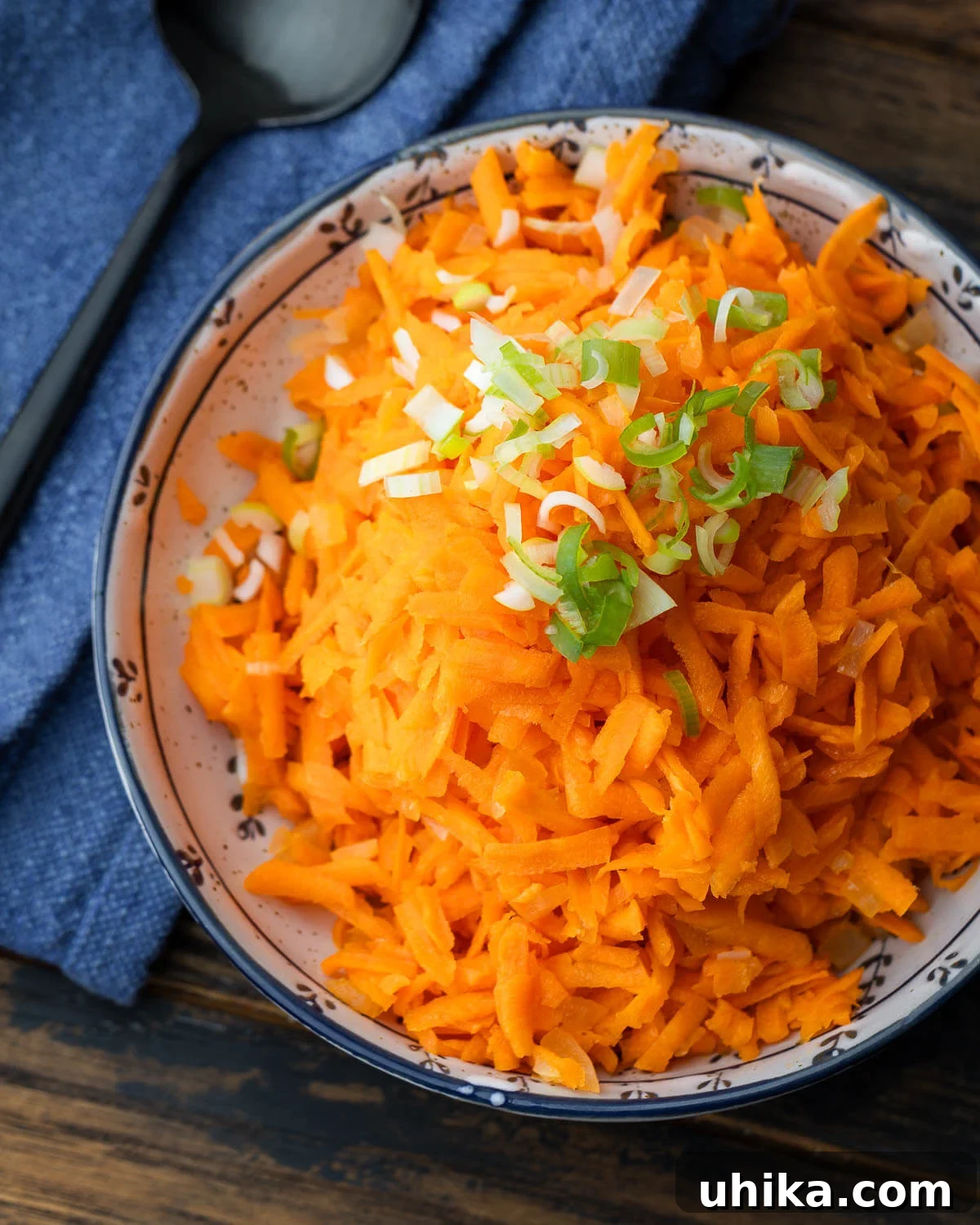 Grandma's Carrot Salad 2 A refreshing Old-Fashioned Carrot Salad in a white bowl, ready to be served.