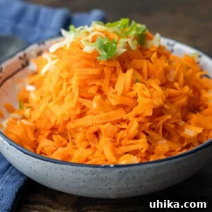 Grandma's Carrot Salad 7 Carrot salad in white bowl topped with green onion.