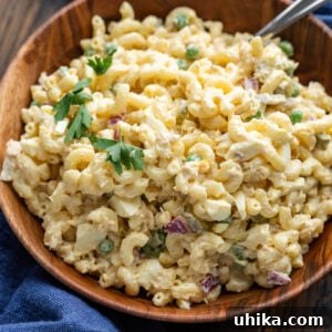 Tuna macaroni salad in a wooden bowl, ready to be served.