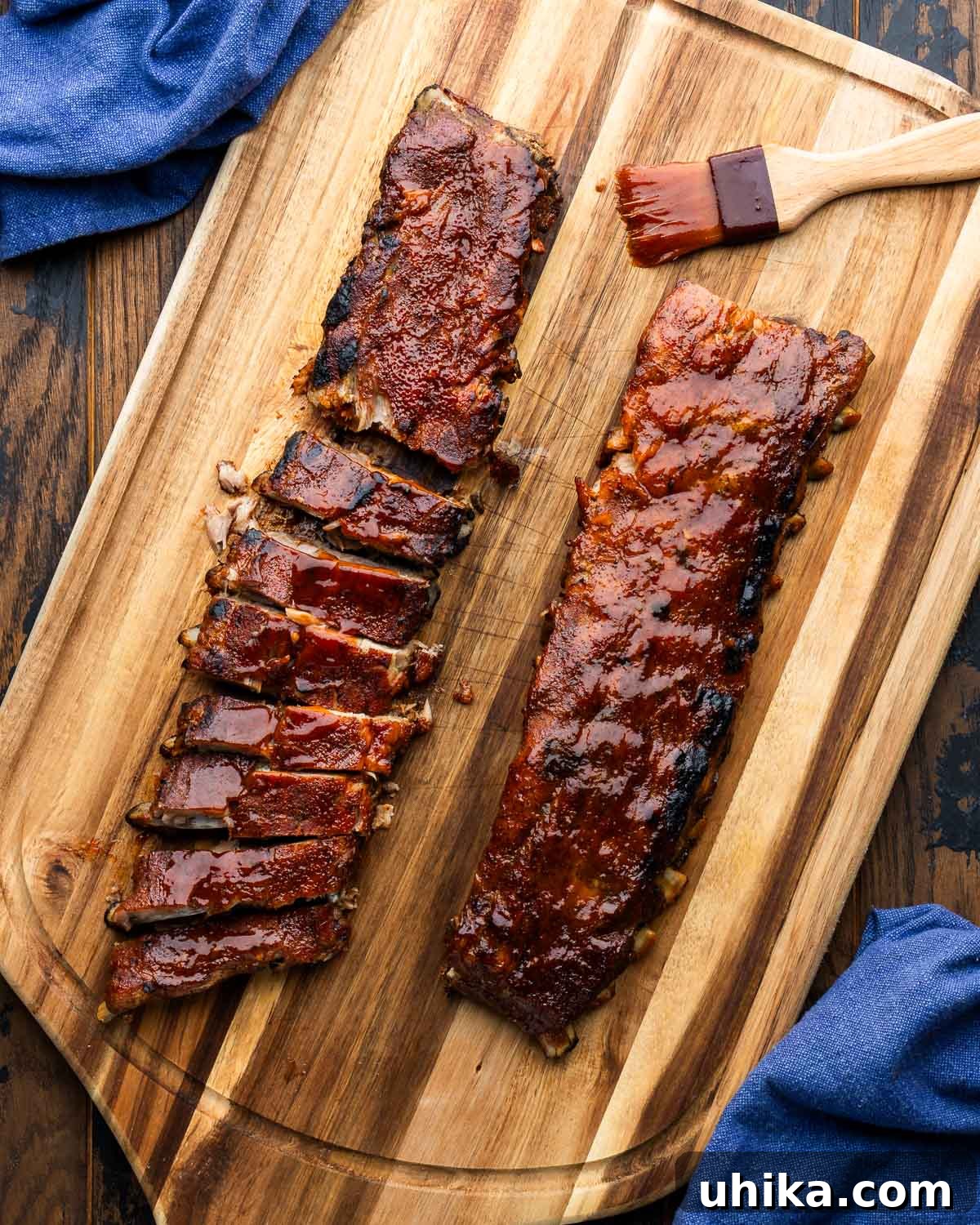 Succulent Oven Ribs with Scratch-Made BBQ 2 Oven bbq ribs sliced on large cutting board, showcasing their tender, juicy texture and rich glaze.
