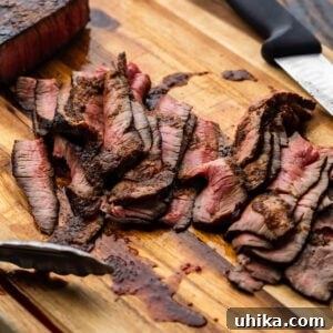 Sliced London Broil on cutting board.