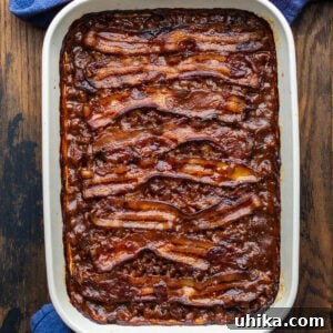 Baked beans in large baking dish.