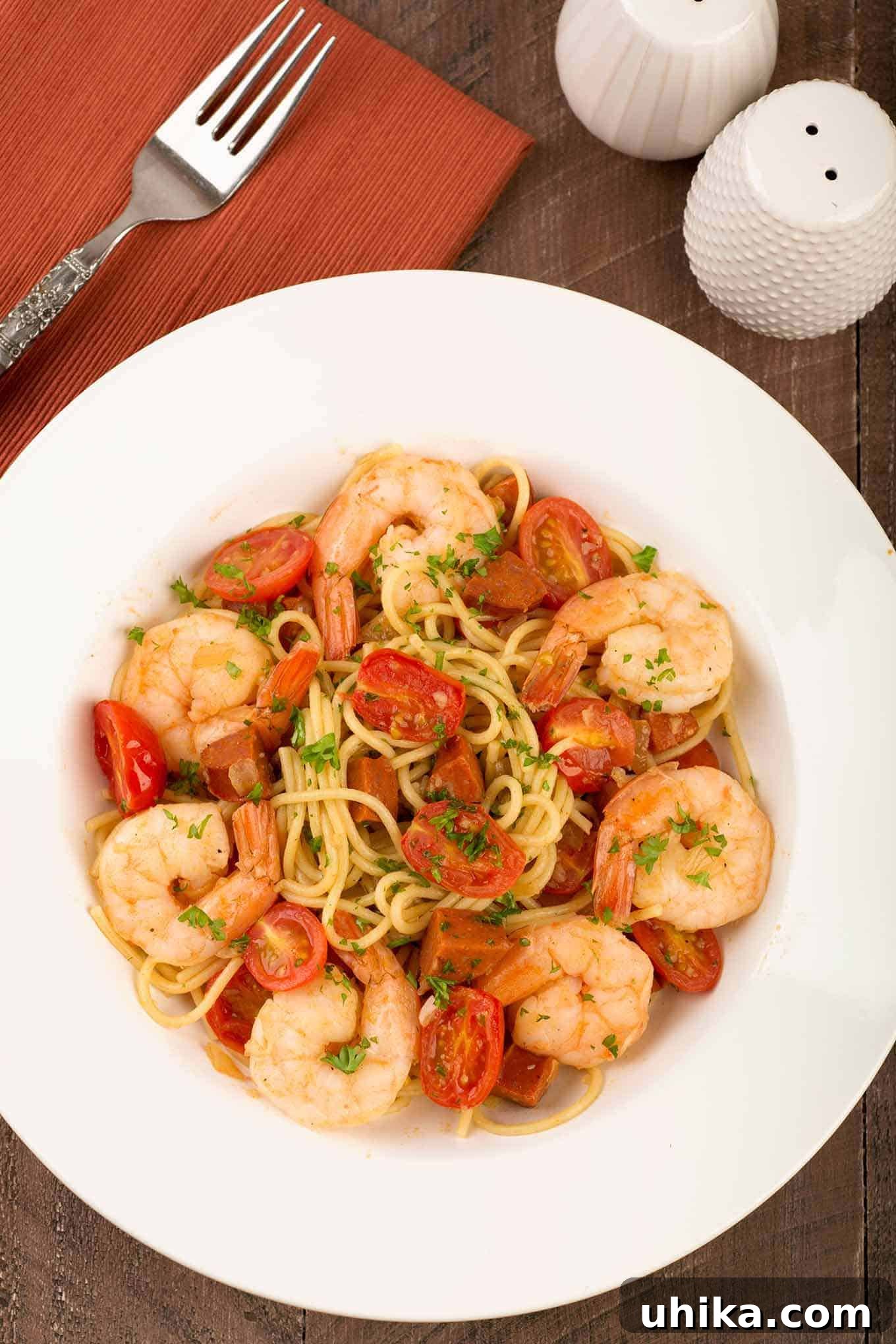 Smoky Chorizo and Shrimp Spaghetti 2 An overhead view of a serving of thin spaghetti tossed with chunks of chorizo, sautéed garlic and onion, jumbo shrimp simmered in sherry, and grape tomatoes.