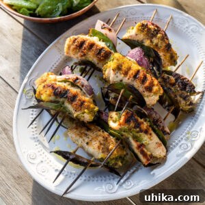 Sicilian Grilled Chicken Spiedini 7 Chicken spiedini on white platter.