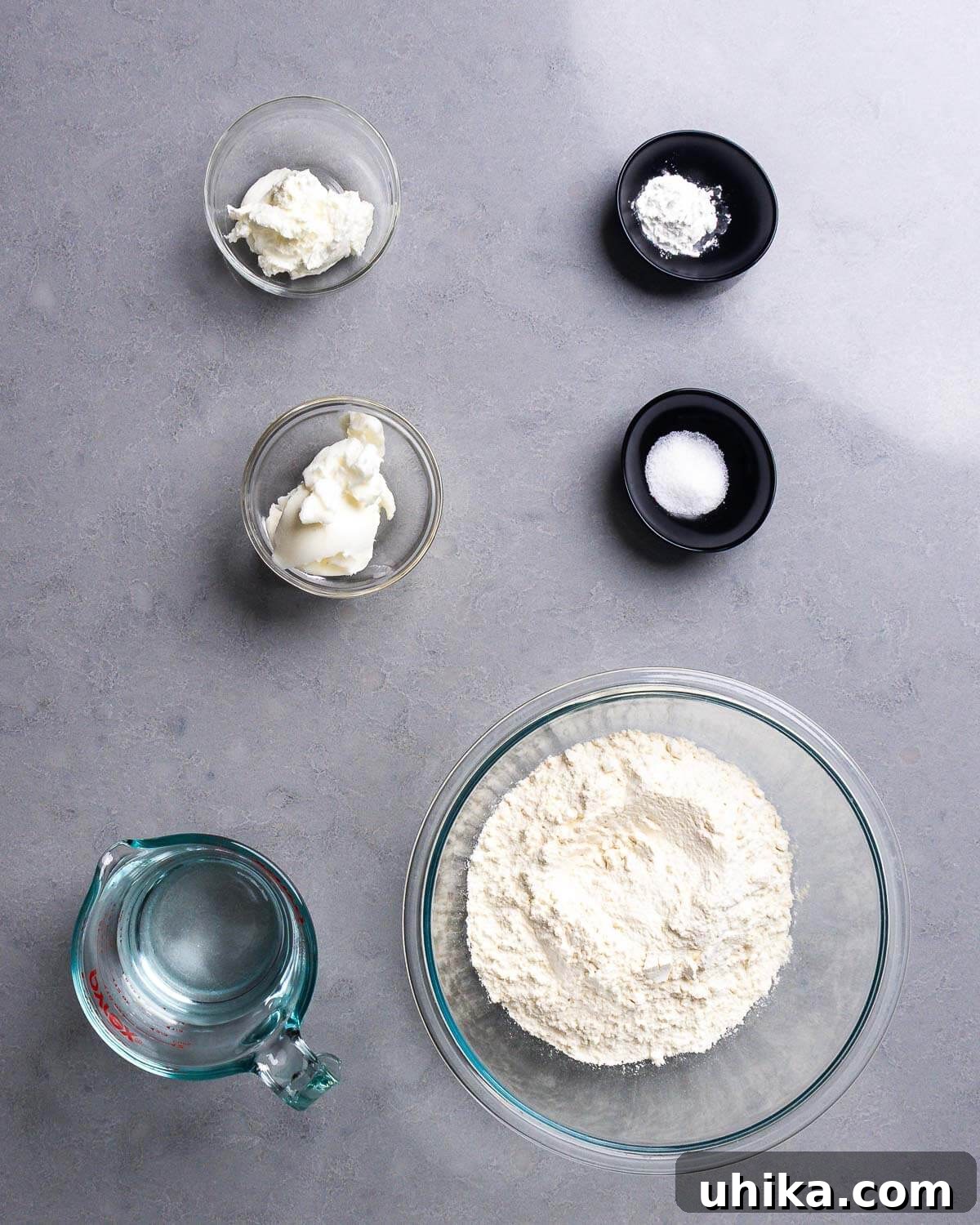 Effortless Pillowy Flatbreads 4 A flat lay photograph of all the essential ingredients for making flatbreads: yogurt, baking powder, salt, lard, water, and flour.