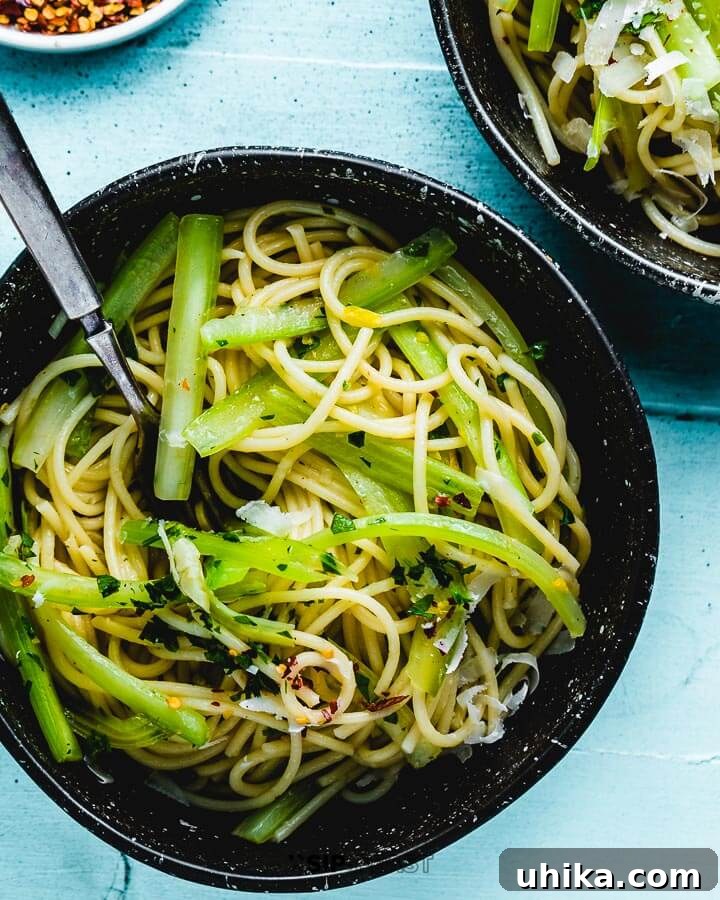 Pasta With Celery - sipandfeast.com #celery #italianpasta #dinner Overhead photo of celery pasta in a bowl on blue table.