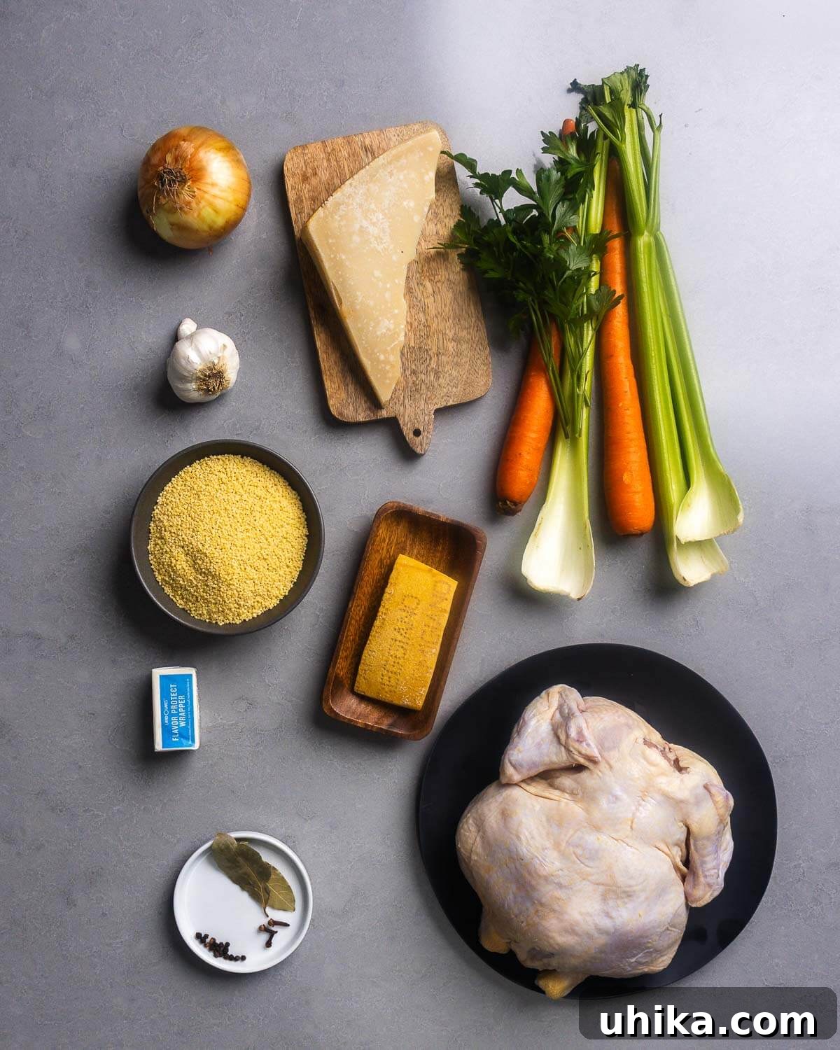 Heartwarming Pastina Broth 4 A beautifully arranged flat lay photograph displaying all the fresh ingredients required for making Pastina in Brodo, including a whole chicken, various root vegetables, fresh herbs, tiny pastina, and high-quality cheese.
