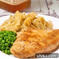 Close-up of a honey whiskey glazed chicken breast.