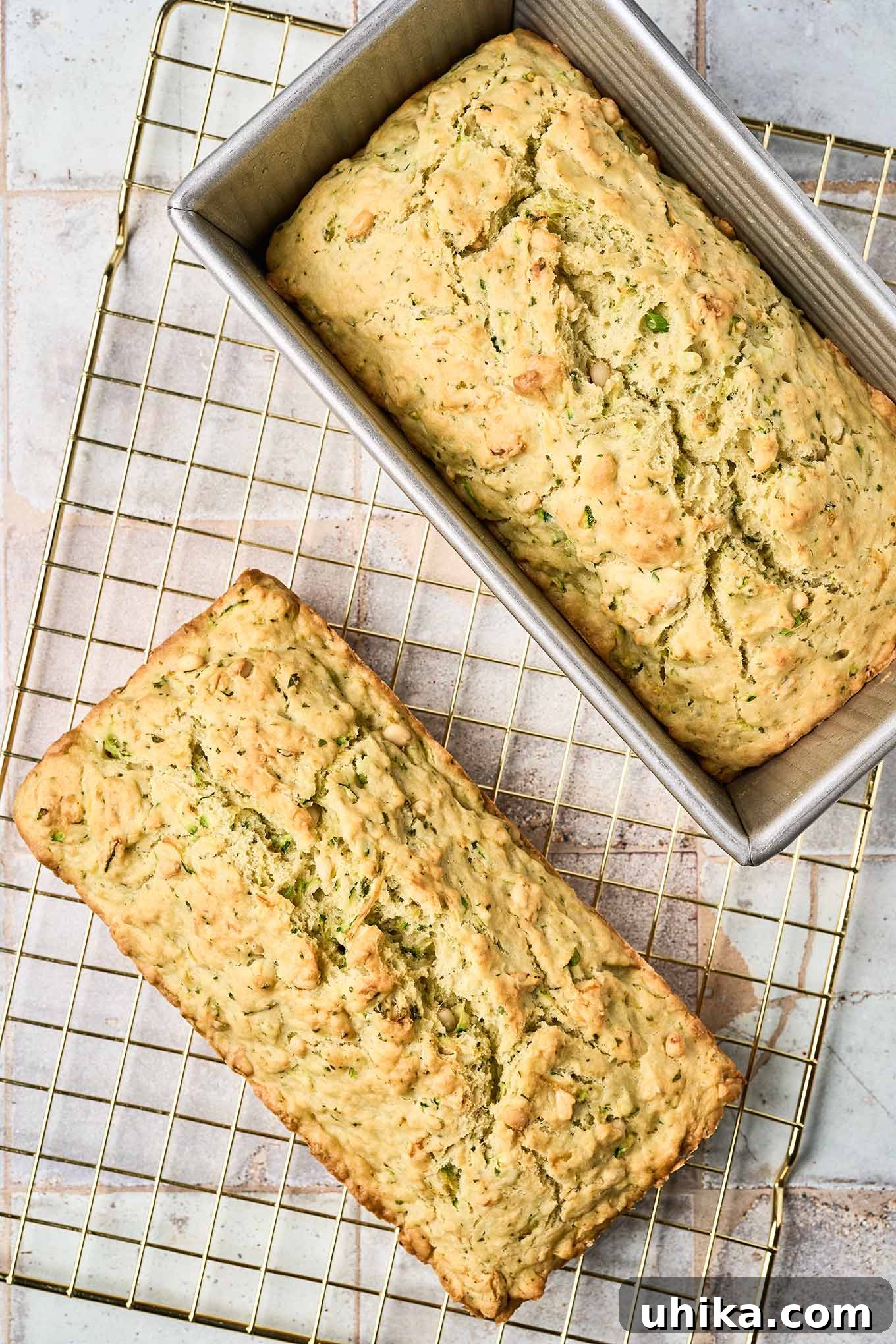 Hearty Savory Zucchini Bread 7 Cooling - the final step in making savory zucchini bread, one loaf directly on a cooling rack, the other still cooling in the pan.