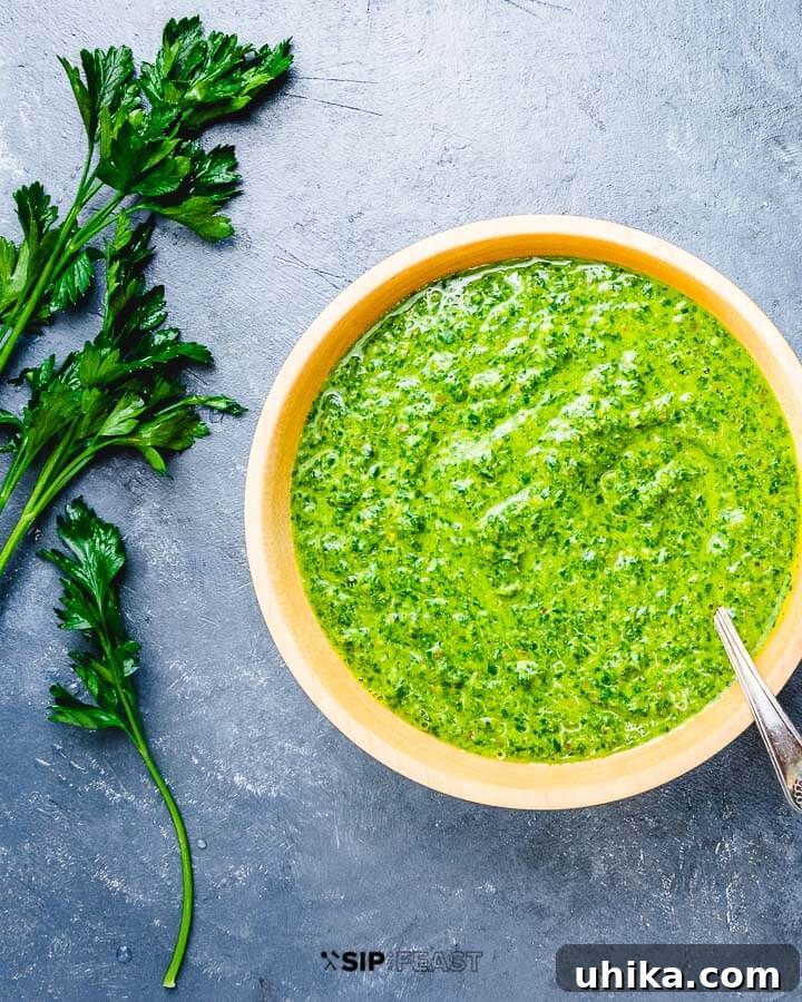 Homemade Italian Salsa Verde - Fresh & Flavorful Italian salsa verde in wooden bowl on blue table. A vibrant green sauce, perfect for grilling.