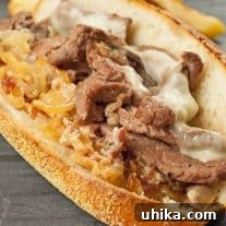 NY Strip Steak Sandwich with Zesty Bacon Horseradish Aioli 3 Close-up of a delicious Strip Steak Sandwich with melted cheese and bacon-horseradish spread on a toasted hoagie roll.
