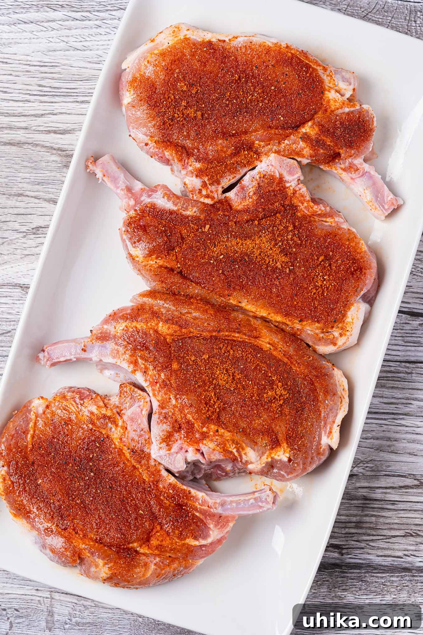 Effortless BBQ Flavor Blend 5 Bone-in pork rib chops coated with BBQ spice rub to illustrate proper application.