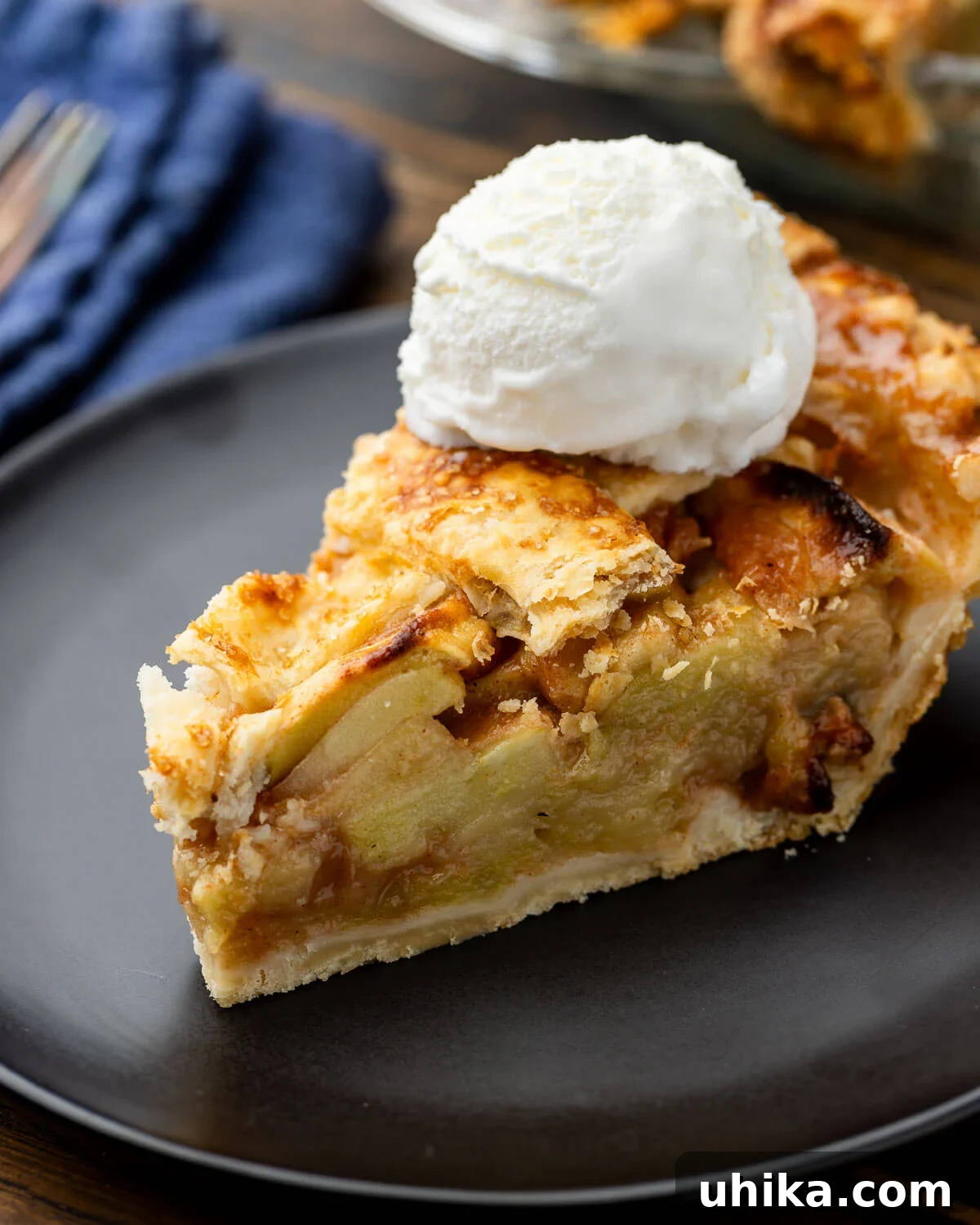 Timeless Flaky Apple Pie 2 Slice of apple pie with vanilla ice cream in black plate.